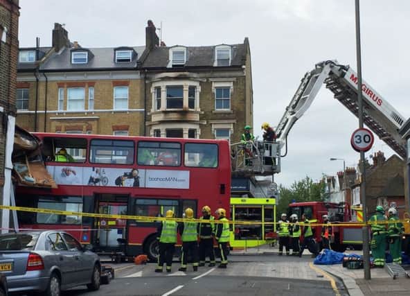 Emergency services at the scene in Lavender Hill, southwest London, after a bus left the road and hit a shop. Picture: Neil Lancefield/PA Wire