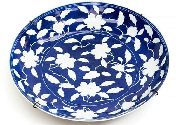 The "exceptional" Chinese dish, carrying the reign mark for Emperor Yongzheng, could fetch up to £100,000 under auction. Picture: PA