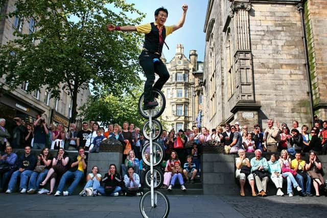 Watching the various street performers in action is one way to save money. Picture: Jeff J Mitchell/Getty Images