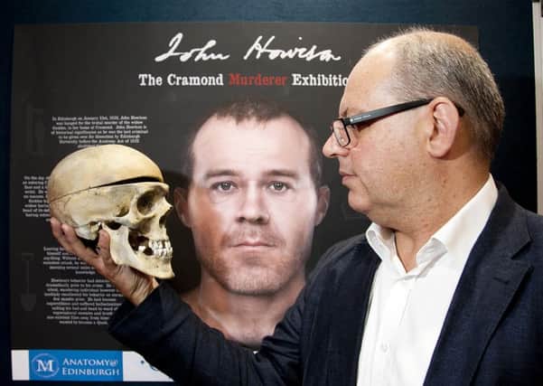 Archeologist John Lawson with the skull and a reconstructed image of John Howison. Photograph: Alistair Linford