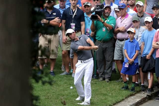Rory McIlroy plays a brilliant low pitch from the rough on the tenth hole. Picture: Getty.