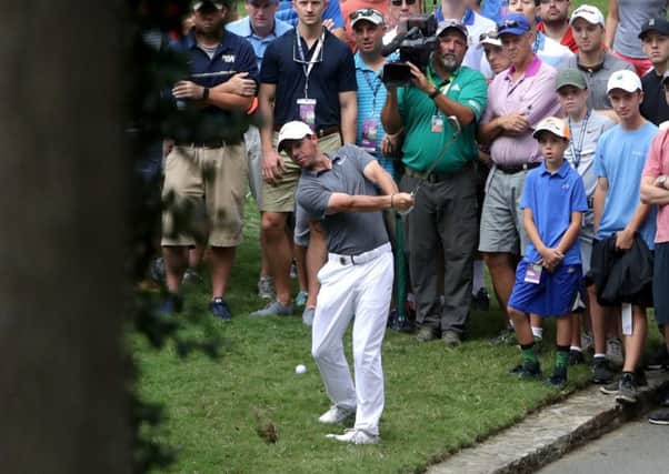 Rory McIlroy plays a brilliant low pitch from the rough on the tenth hole. Picture: Getty.