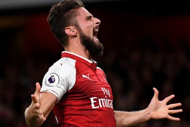 Arsenal striker Olivier Giroud celebrates scoring his sides dramatic winning goal last night. Picture: Getty.