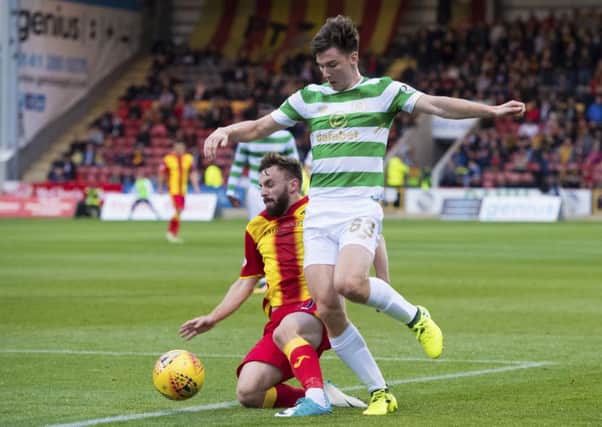 Kieran Tierney rides a challenge by Steven Lawless. Picture: SNS