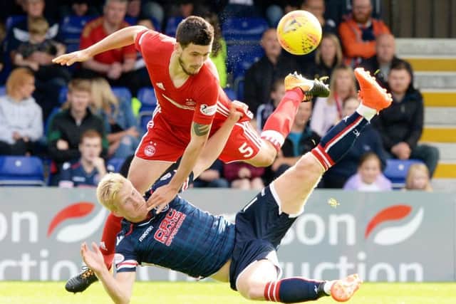Aberdeen's Anthony O'Connor and Ross County's Thomas Mikkelsen battle. Picture: SNS/Paul Devlin