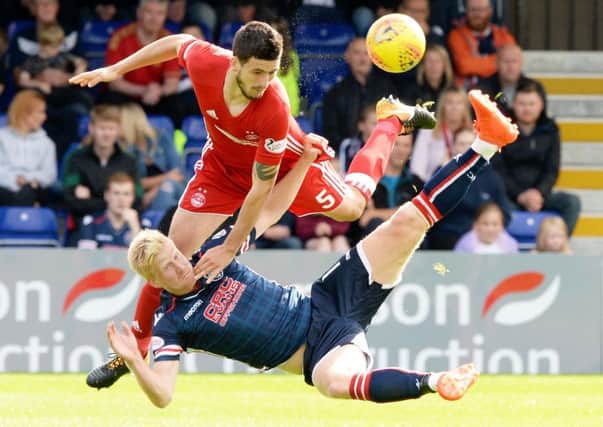 Aberdeen's Anthony O'Connor and Ross County's Thomas Mikkelsen battle. Picture: SNS/Paul Devlin