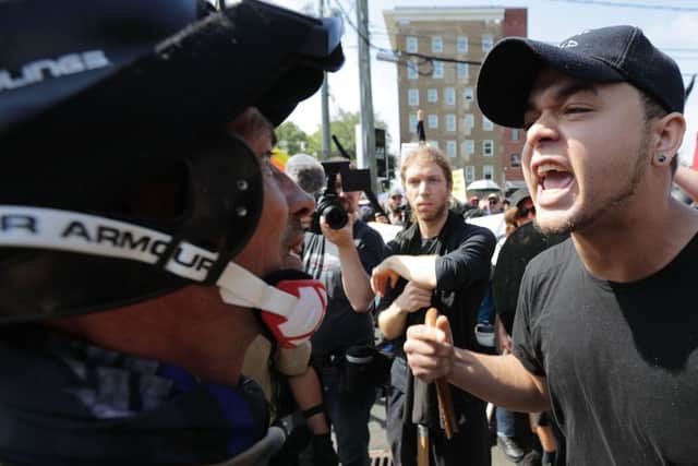 White nationalists, neo-Nazis and members of the "alt-right" exchange insults with counter-protesters as they enter Lee Park during the "Unite the Right" rally. Picture: Chip Somodevilla/Getty Images