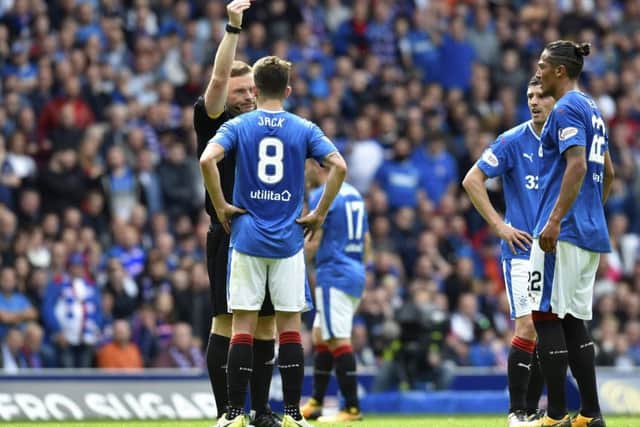 John Beaton shows Rangers' Ryan Jack the red card which has angered fans. Picture: SNS/Rob Casey