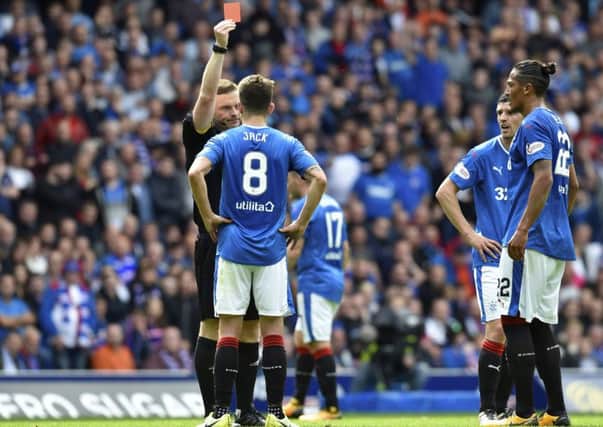 John Beaton shows Rangers' Ryan Jack the red card which has angered fans. Picture: SNS/Rob Casey