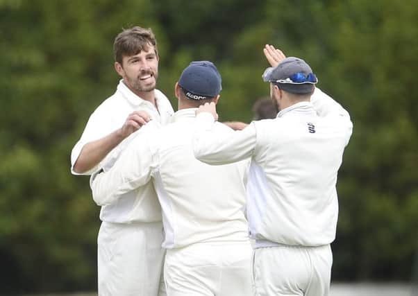 Grange bowler James Tapper, left, celebrates after claiming the wicket of Arbroath opener Brendon Ford. Picture: Greg Macvean.