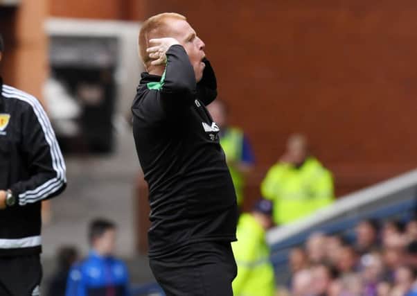 Neil Lennon made an arm gesture towards the Rangers supporters. Picture: SNS.