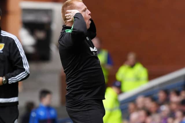 Neil Lennon made an arm gesture towards the Rangers supporters. Picture: SNS.