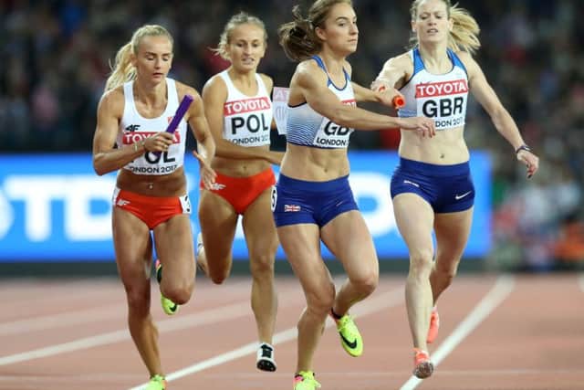 Eilidh Doyle, right, hands over to Emily Diamond in the 4x400m relay final. Picture: PA.
