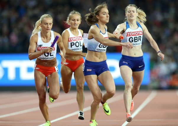 Eilidh Doyle, right, hands over to Emily Diamond in the 4x400m relay final. Picture: PA.