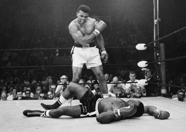 Muhammad Ali stands over Sonny Liston on May 25, 1965, in Lewiston, Maine. Picture: AP
