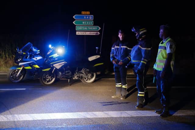 Police block a road near where a man rammed a car into a pizza restaurant near Paris. Picture: AFP