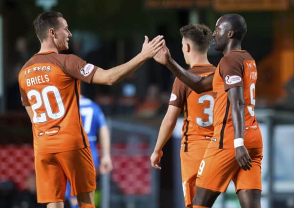 Patrick N'Koyi celebrates his second goal with Dundee United team-mate and fellow Dutchman Jordie Briels at Tannadice. Picture: SNS