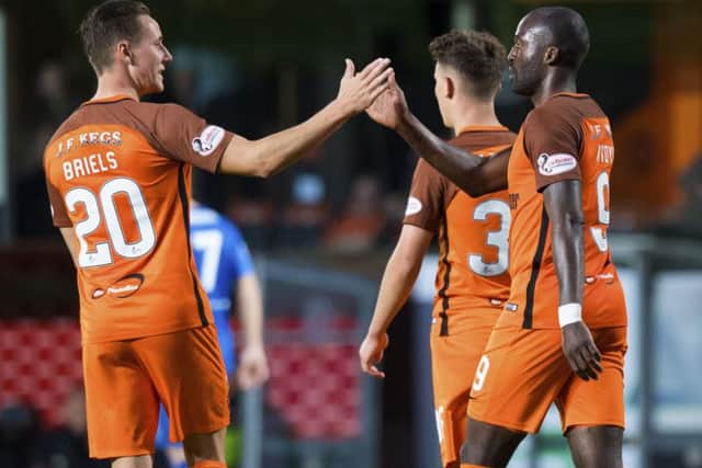 Patrick N'Koyi celebrates his second goal with Dundee United team-mate and fellow Dutchman Jordie Briels at Tannadice. Picture: SNS