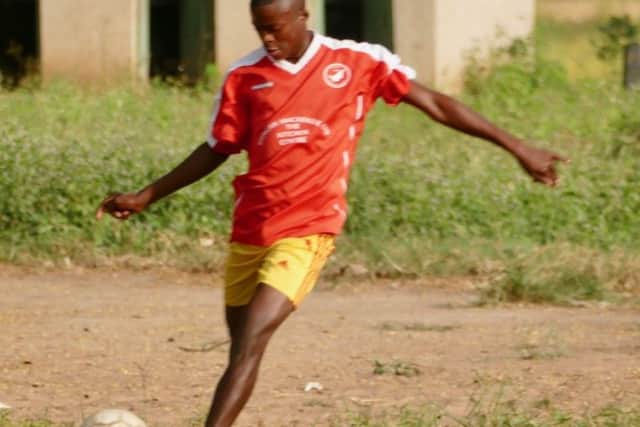 A barefoot Kiogosi player shows off his ball skills in his new Point top. Picture: Supplied