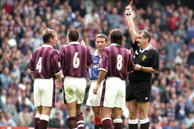 Referee Gerry Evans shows the first of four red cards to Pasquale Bruno. Picture: SNS