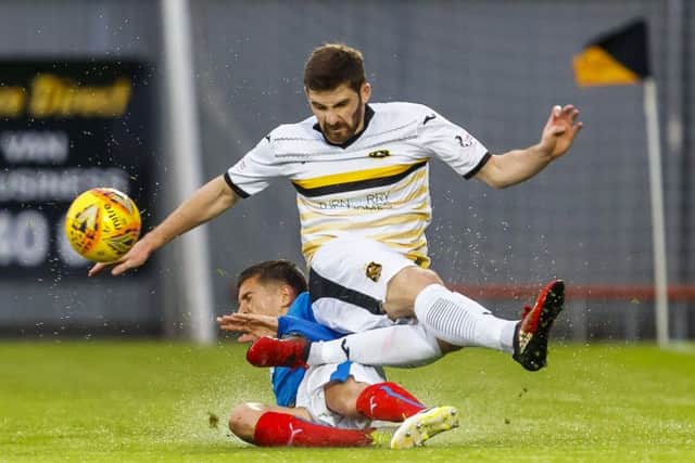 Dumbarton midfielder Kyle Hutton gets the better of Rangers U20s Myles Beerman. Picture: Roddy Scott/SNS