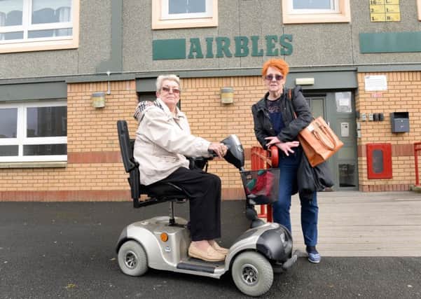 Margaret Grier (L) and Vicky Turner outside Airbles Tower. Neighbours had to carry Margaret's mobility scooter down the stairs so she could get out. Picture: SWNS