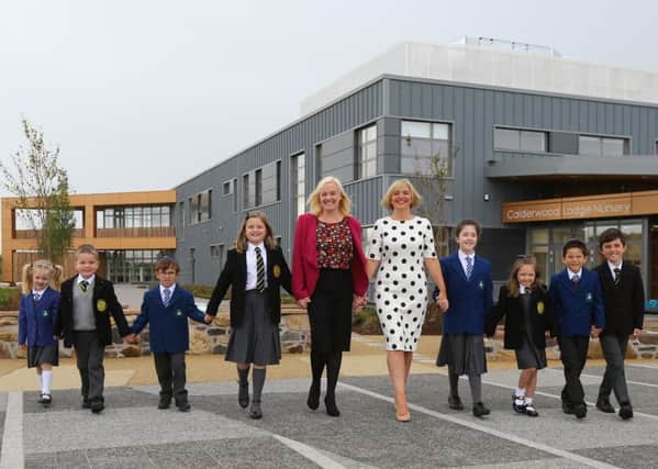 St Clare's primary Head teacher Anne Marie Absolom, left and Calderwood Lodge primary head teacher Marion Carlton with pupils from both schools. Picture: SWNS