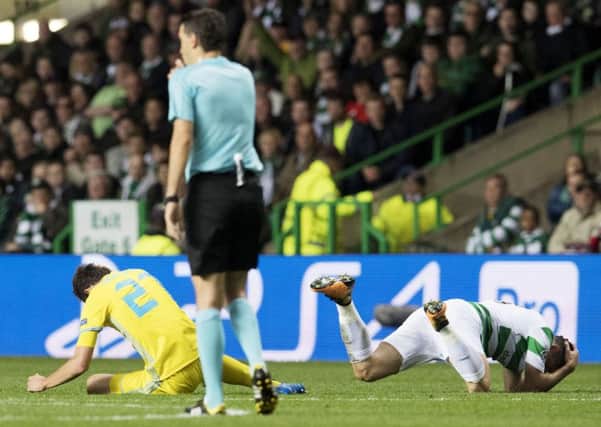 Celtic's Tom Rogic, right, and Astana's Yuri Logvinenko on the pitch after a clash of heads. Picture: SNS