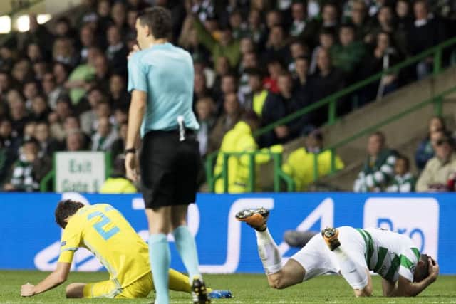 Celtic's Tom Rogic, right, and Astana's Yuri Logvinenko on the pitch after a clash of heads. Picture: SNS