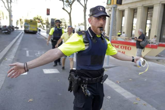 A police officer cordon off a street in Barcelona, Spain. (AP Photo/Manu Fernandez)