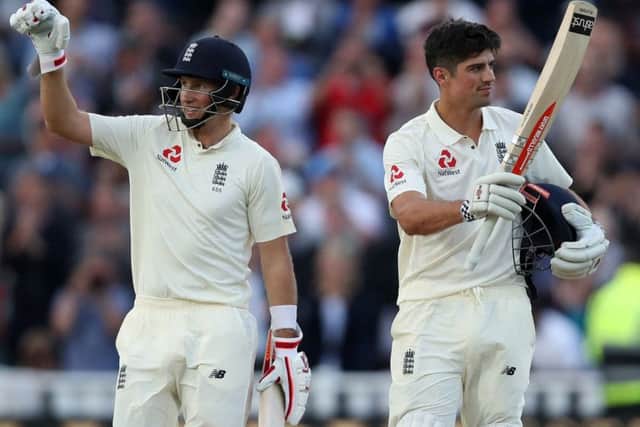England's Alastair Cook, right, celebrates his ton with fellow centurion Joe Root during the first day of the First Investec Test at Edgbaston. Picture: Nick Potts/PA