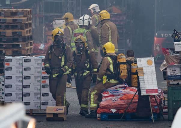 Firefighters attend the scene of the blaze at Blochairn Fruit Market. Picture: Getty Images