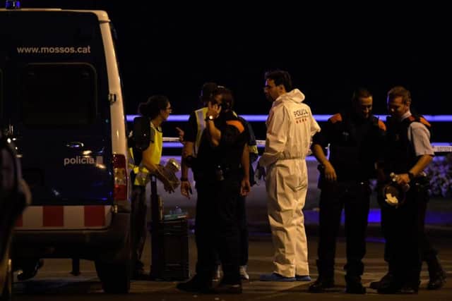 Police officers check the area after police killed five attackers in Cambrils near Tarragona. Picture: AFP