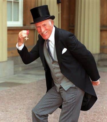Sir Bruce Forsyth with his OBE in 1998. Picture: John Stillwell/PA Wire