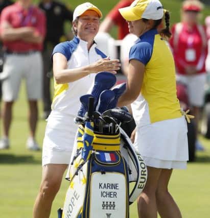 Catriona Matthew, left, of Scotland, celebrates with teammate Karine Icher, of France, after winning their foursome match against the United States. Picture: Charlie Neibergall/AP