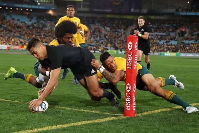 Rieko Iaone carves through the despairing Wallabies defence to notch one of two tries as the All Blacks hammered Australia in Sydney. Photograph: Mark Kolbe