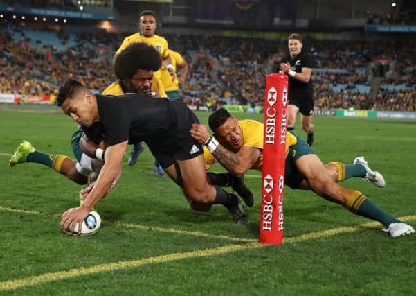 Rieko Iaone carves through the despairing Wallabies defence to notch one of two tries as the All Blacks hammered Australia in Sydney. Photograph: Mark Kolbe