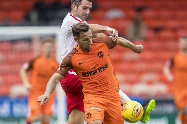 Dundee United's Scott MacDonald holds off Brechin's Paul McLean. Picture: SNS/Bill Murray