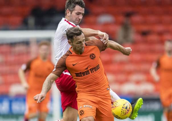 Dundee United's Scott MacDonald holds off Brechin's Paul McLean. Picture: SNS/Bill Murray