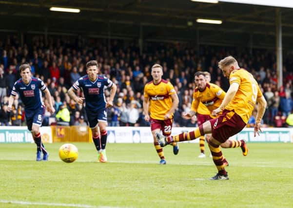 Motherwell's Louis Moult scores from the penalty spot to make it 2-0. Picture: SNS/Roddy Scott