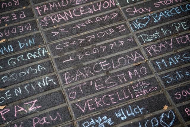 Messages are written on the ground on Las Ramblas near the scene.  (Photo by Carl Court/Getty Images)