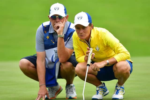 Scotlands Catriona Matthew lines up a putt with her caddie Mike Patterson yesterday. Photograph: Getty Images