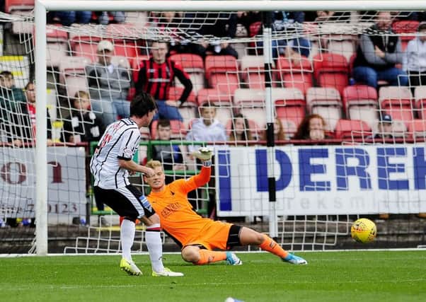 Joe Cardle scores his second goal to add the gloss to Dunfermlines victory. Picture: Michael Gillen.