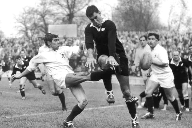 Colin Meads charges down a kick by Midlands and England scrum-half Bill Gittings during a match in Leicester in 1967. Picture: Central Press/Hulton Archive/Getty