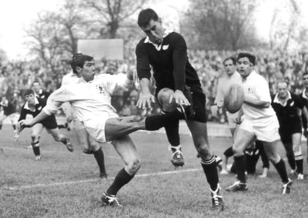 Colin Meads charges down a kick by Midlands and England scrum-half Bill Gittings during a match in Leicester in 1967. Picture: Central Press/Hulton Archive/Getty