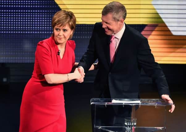 First Minister Nicola Sturgeon shakes hands with
 Scottish Liberal Democrat leader Willie Rennie. Picture: Getty Images