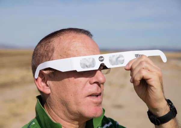 A total eclipse enthusiast tries out protective eye wear in Oregon, United States. Picture: AFP/Getty Images