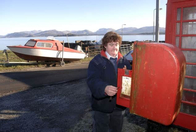 Post bus driver Alison MacLean collects mail from a post box in Achnacroish. Picture: Ian Rutherford/TSPL