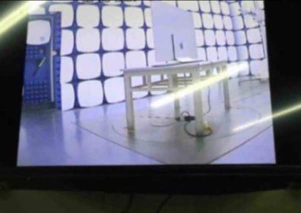 Blurry pictures posted on a Chinese microblogging site appear to show an Apple-branded television screen in a test lab. Picture: SWNS.com