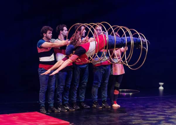 Flip FabriQue occupy themselves with a remarkably skilful hula hoop routine. Picture: Ian Georgeson